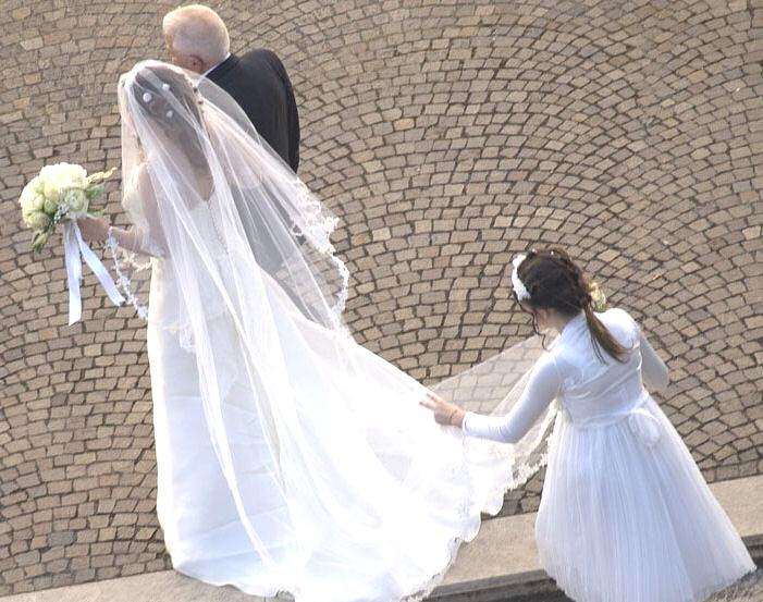 Bride and Father with bridesmaid holding
                        train