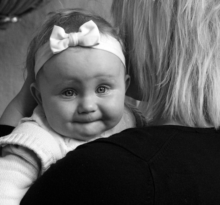 Baby being held on shoulder of
                          woman