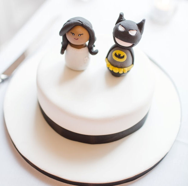 Single tier
                      wedding cake with figurines of a bride and Batman
                      on it