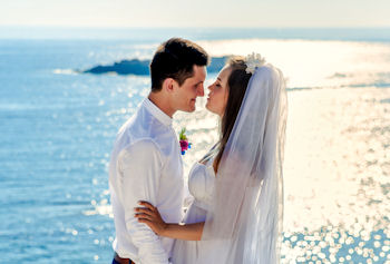 Bride and Groom with backlit sea glare