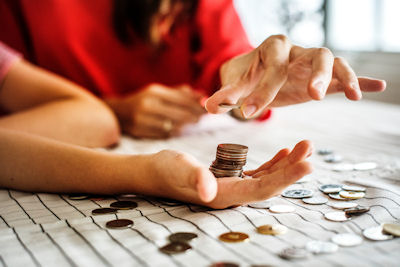 Two people counting coins