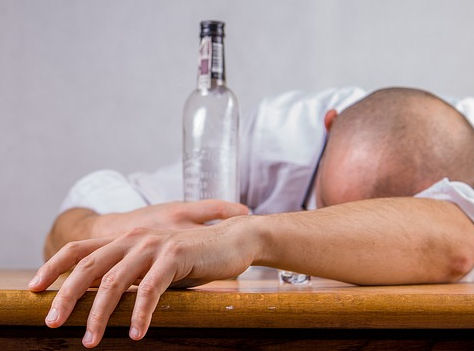 Drunk groom with bottle of alcohol