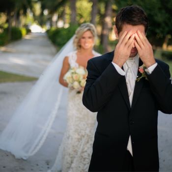 Groom
                          covering his eyes with his hands as bride
                          approaches from behind