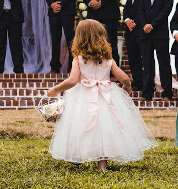 Flower girl tossing
                  petals