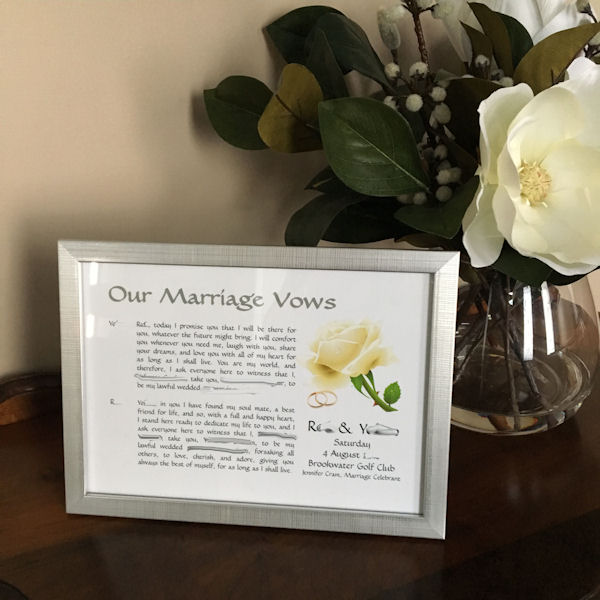 Wedding Vows in Silver Frame next to vase of
                      white magnolia flowers