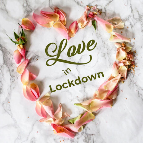 The words Love in Lockdown surrounded by
                        rose petals in the shape of a heart