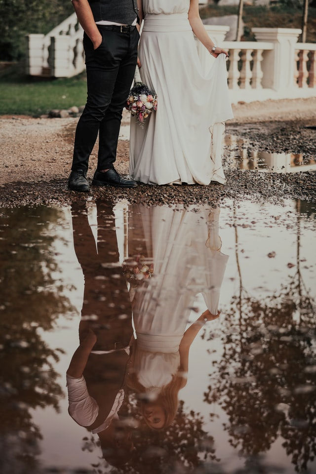 Marrying couple
                      reflected in water