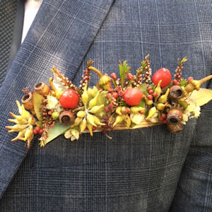 Pocket posy made of Australian native
                          flowers and gumnuts and succulents in autumn
                          tones