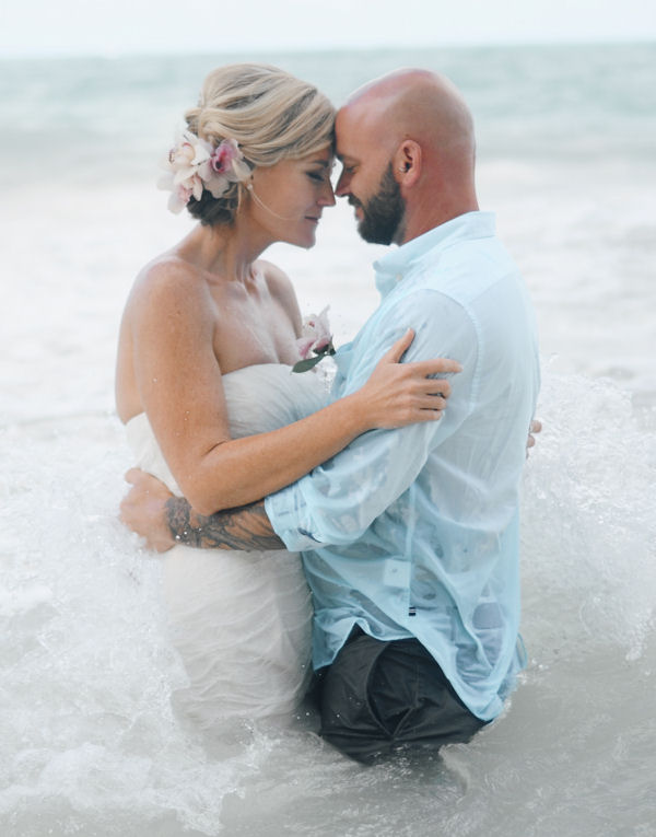 Bride and Groom standing in water