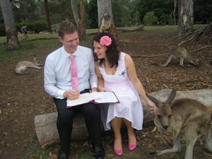 Signing the register surrounded by
                    kangaroos