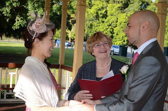 Hiromi
                        & Leigh sharing a happy moment with
                        celebrant Jennifer Cram during their Warm and
                        Wonderful Weekday Wedding