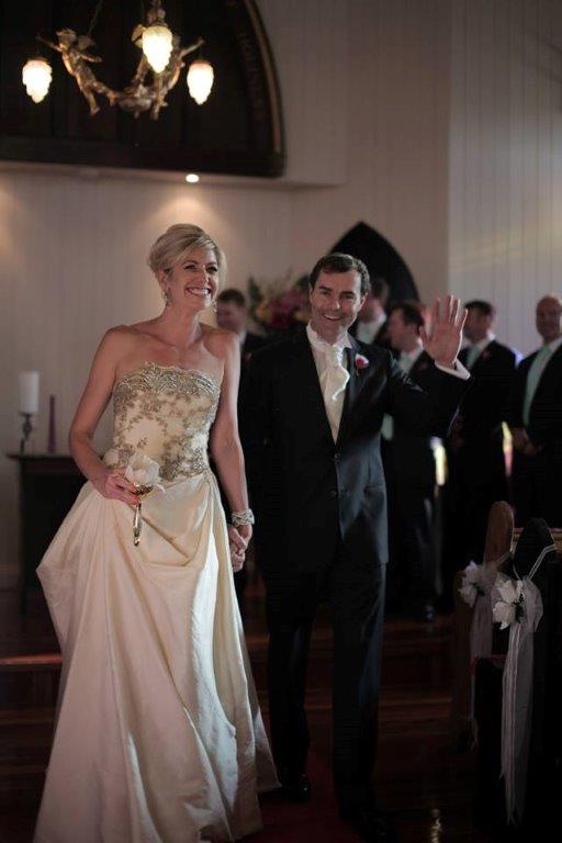 Katie & Lachie
                        walk back up the aisle after their 'white
                        wedding' renewal of vows at the Broadway Chapel